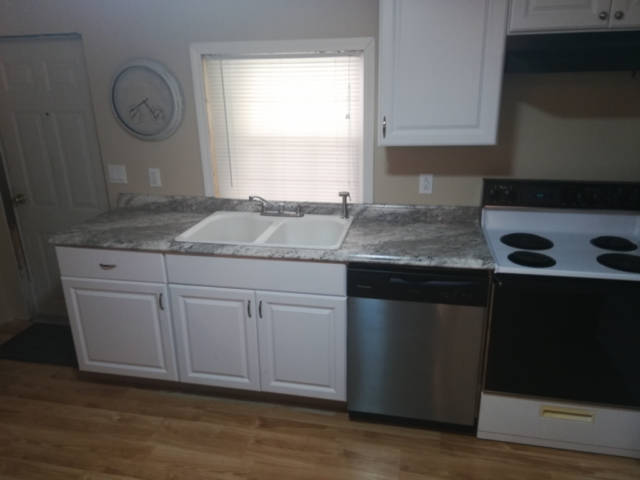 stock kitchen renovation with white cabinets formica countertops and cast iron white sink