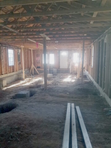 crawlspace foundation repairs with wall and roof framing still standing