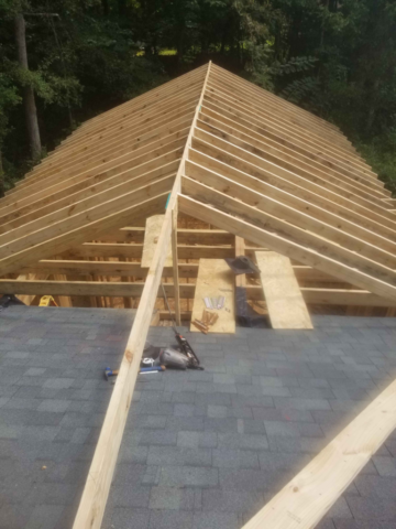 roof framing rafters for home addition partially finished ridge pole board framing gun nailer