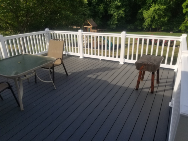 TREX gray deck with white PVC plastic handrails newly installed
